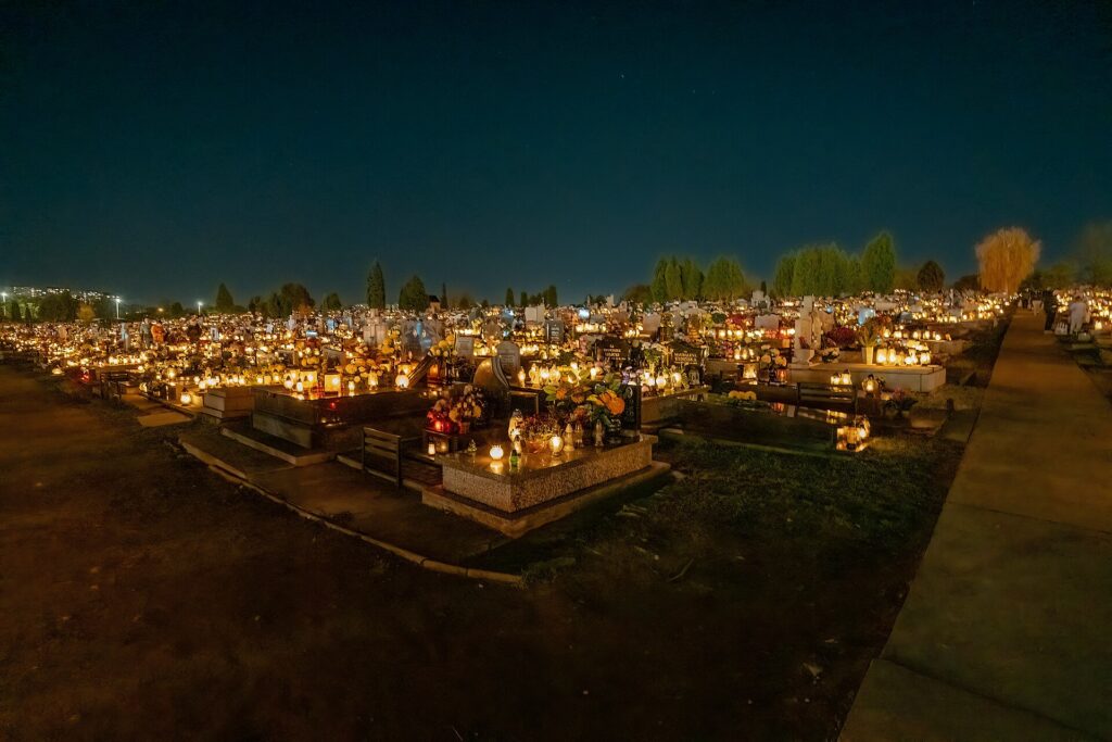 Night-time cemetery vigil with candles during Day of the Dead in Mexico