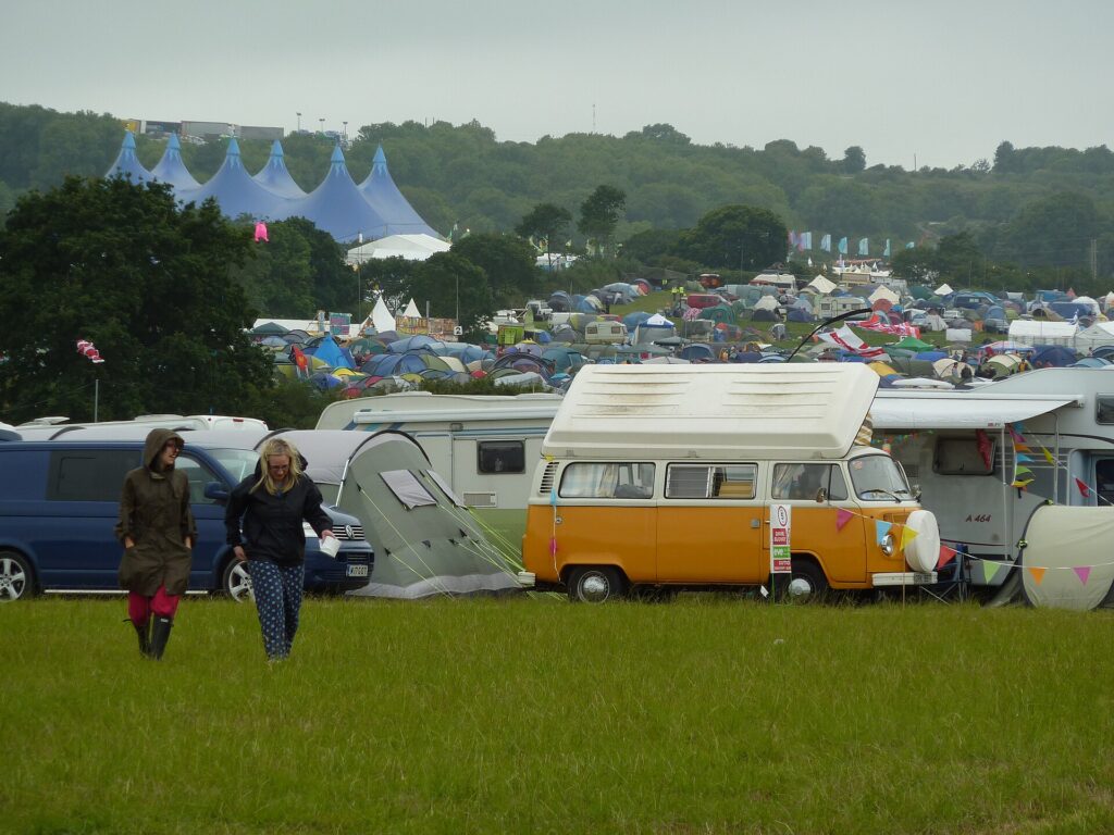 Pre-pitched canvas tents and campervans in a festival boutique campsite