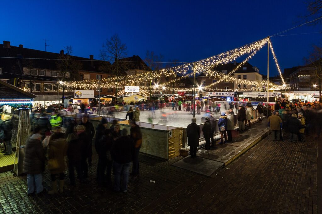 Christmas market stalls and an ice rink on the market square in Dülmen, Germany