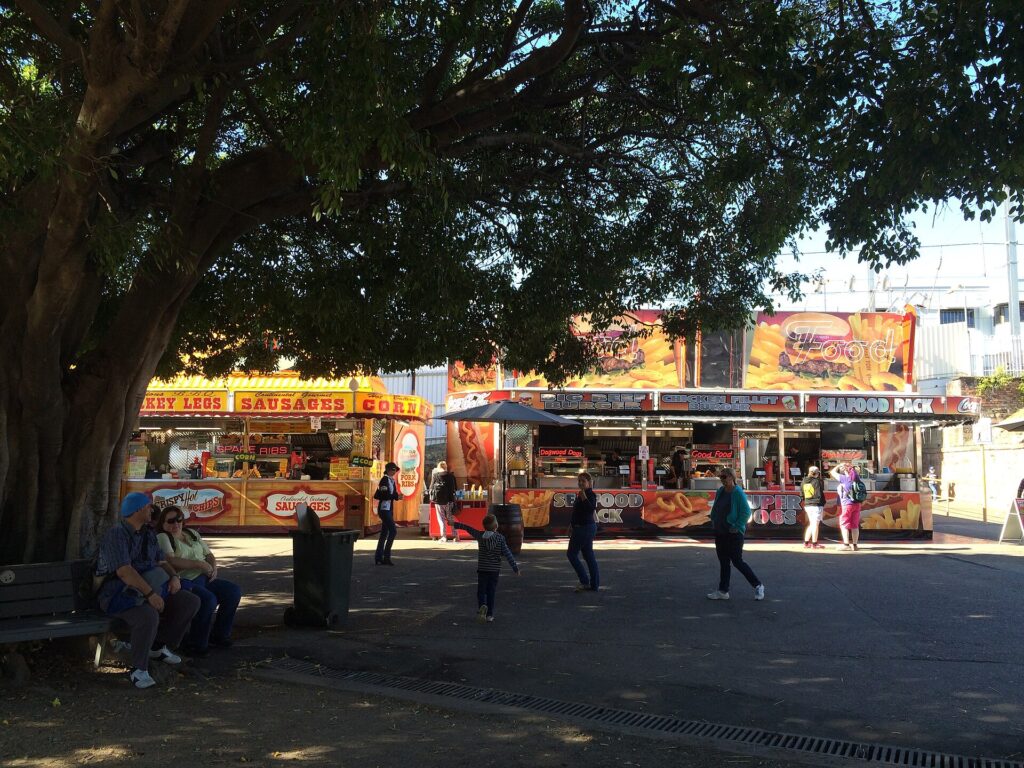 Food stalls under spreading trees at the Ekka in Brisbane