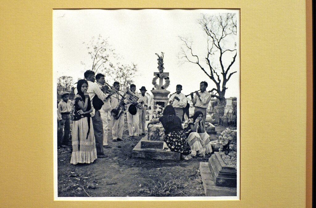 Candlelit graves decorated with marigolds at night in an Oaxaca cemetery