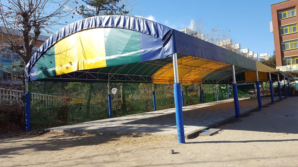 Shade canopy stretched over tents at a hot campground