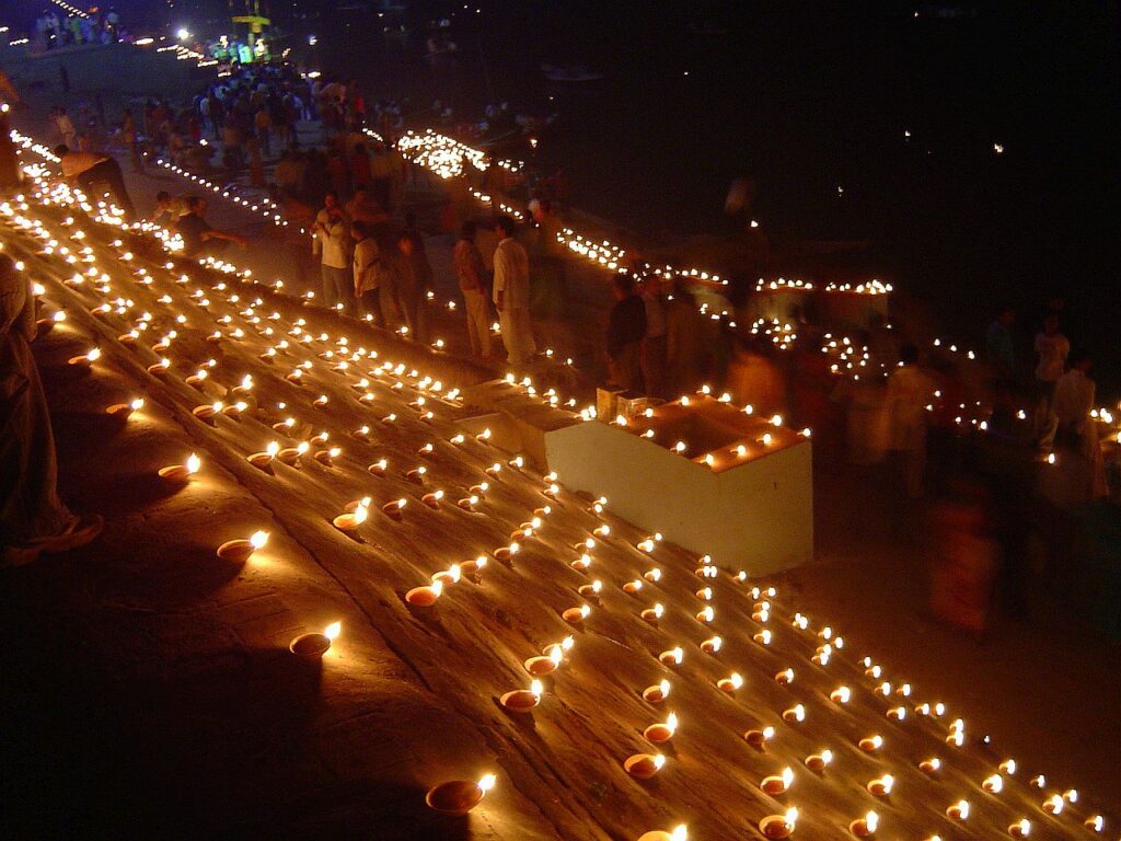 Ghats on the Ganges at Varanasi lit with rows of oil lamps at night