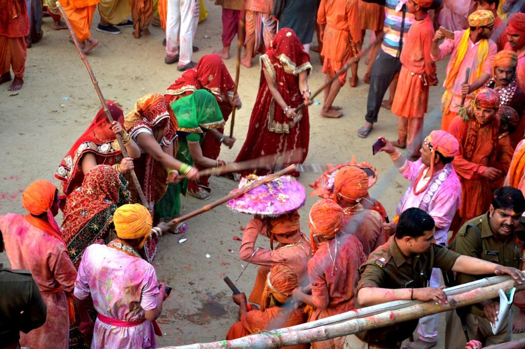 Women playing Lathmar Holi with wooden sticks in Barsana