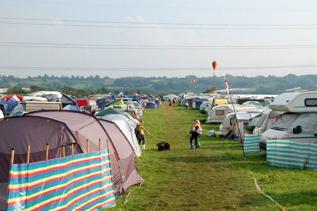 Campsite tents and power lines at a festival