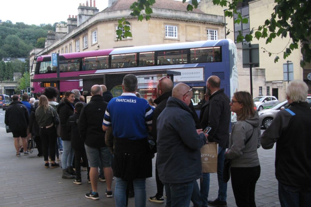 Passengers queueing to board a shuttle bus at a park and ride lot